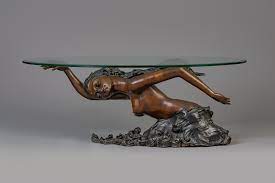 A Bronze Mermaid Coffee Table With Oval