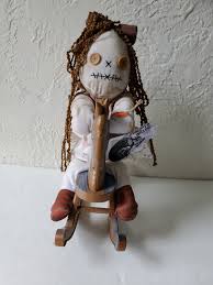 haunted rag doll on rocking horse