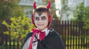 little boy wearing makeup devil horns