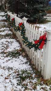 lighted garland on the picket fence