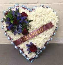 Based white closed heart tribute, ribbon edging and flower cluster available in any colour of your choice red, orange, yellow, purple, pink etc. Team Colours Based Funeral Heart Blossom Florists For Essex Delivery