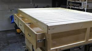 a queen size bed frame with 3 drawers
