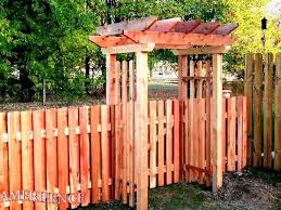 wooden fence with gated entry arbor