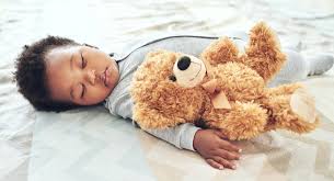 baby sleep with a stuffed animal