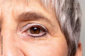 aged woman waring blue eye shadow