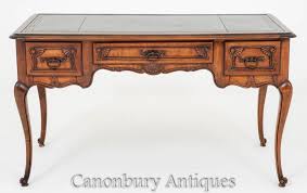 Tapering, fluted legs lend it the airy expansiveness of the traditional library tables upon which the earliest partner's desks were based. Antique French Desk Cherry Wood Writing Table Bureau