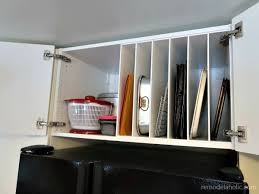 The ikea's special kitchens are make up of lower ikea kitchen cabinets, upper cabinets and kitchen counters. Remodelaholic Ikea Hack Diy Over The Fridge Cabinet Organizer For Cookie Sheets And Cutting Boards