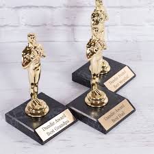 In order to maintain morale, everybody gets a dundie. Personalized Dundie Trophies Jane