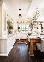 Painted in a benjamin moore white, the kitchen of a nova scotia home designed by alexander gorlin is centered by an island clad in caesarstone; Large Wood Kitchen Island With Black And White Stripe Stools Transitional Kitchen