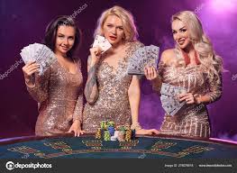 Beautiful girls with a perfect hairstyles and bright make-up are posing  standing at a gambling table. Casino, poker. Stock Photo by  ©nazarov.dnepr@gmail.com 278079518