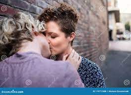 Affectionate Young Leasbian Couple Standing Outside Sharing a Kiss Stock  Photo - Image of outside, smiling: 119717488