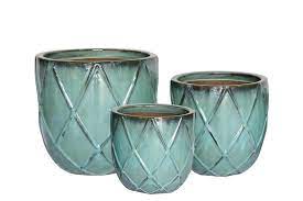 h teal ceramic planter in the pots