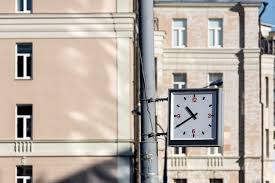 Square Street Clock Hanging On A Pillar