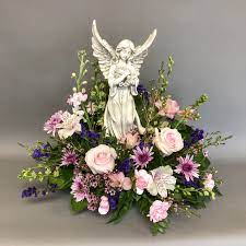 Sympathy flowers with angel keepsake. Angel Sympathy Floral Arrangement Sympathy Floral Funeral Flower Arrangements Funeral Floral