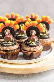 Fun feather thanksgiving cupcake toppers perfect as a kids craft while waiting for the food to cook! Thanksgiving Turkey Cupcakes Brown Eyed Baker