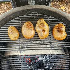 baked potato on the grill open fire