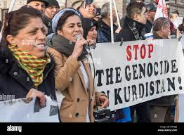 A woman speaks at the protest calling for Turkey to recognise Kurdish  rights and end their support for ISIS in Syria and Iraq and genocidal  attacks by Turkish forces on Kurdish towns