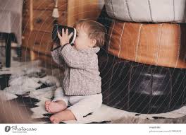 cute baby boy playing with cup at home