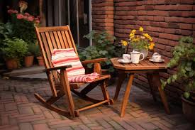 A Wooden Rocking Chair On A Brick Patio