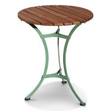 A Round Garden Table With Green Metal Legs