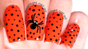 spider design on dotted orange nail art