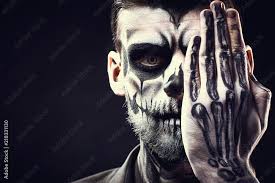 face of man with halloween skull makeup