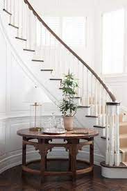 Christine orlando at may 2, 2021 10:00 am. Foyer Area With Curved Staircase And A Round Wooden Table Orrick And Company Staircase Decor Foyer Decorating Entryway Stairs