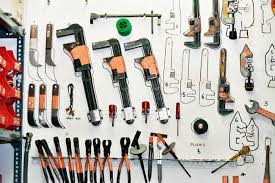 Front View Of Tools Hanging On Wall