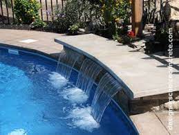 See more ideas about pool water features, swimming pool water, rock waterfall. Concrete Bench Over Pool Water Feature Pool Water Features Pool Waterfall Pool Fountain