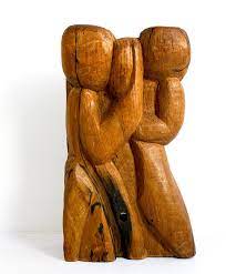 brutalist hand carved sculpture in wood