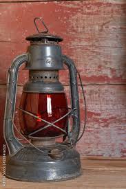 Antique Red Glass Oil Lamp On Red Barn