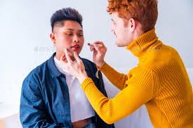 beautiful couple putting on makeup