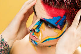 colored face paint on yellow background
