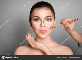 makeup artist contouring woman s face