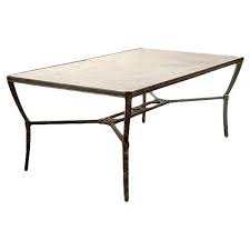 It is white in color with a polished texture and has a good contrast with the black wrought iron chairs. Jane Modern French Stone Top Metal Outdoor Dining Table 41 D 50 D Kathy Kuo Home
