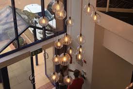 We carry a variety of commercial pendant lighting fixtures available for delivery, and to your specifications. Lighting A High Ceiling Try A Large Multi Pendant Chandelier Like In The Tall Office Stairwell