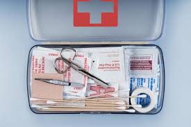 First Aid Kit Packed with Medical Supplies on Grey Background