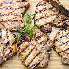 marinated pork chops on the grill two