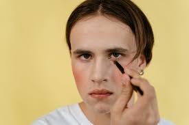 a man applying makeup on his face