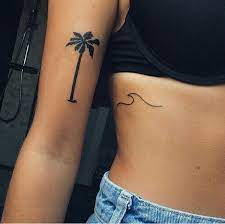 Sunset and beach palm tree tattoo on side rib. Palm Tree Wave Tattoo