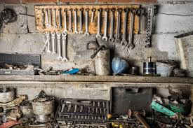 tools hanging on a wall in a tool shed