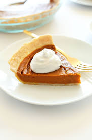 small plate with a slice of vegan gluten free pumpkin pie topped with coconut whipped