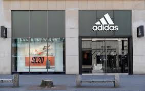 Adidas shrugs off China boycott call to raise outlook | Reuters