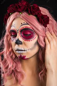woman with sugar skull makeup and pink