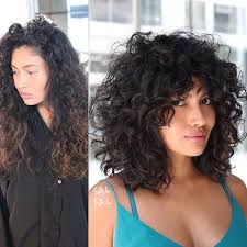 A hairstyle with straight bangs can make round faces look rounder, unless the bangs remain above the brow line. Curly Hair Lob With Bangs Best Short Curly Hair Ideas In 2019 Curly Hair Styles Naturally Curly Hair Styles Curly Hair With Bangs