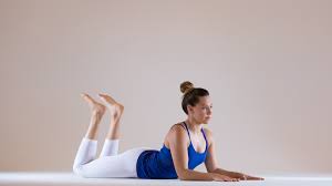 Beautiful woman practicing yoga, seated forward bend, paschimottanasana. A Lower Back Focused Yin Sequence