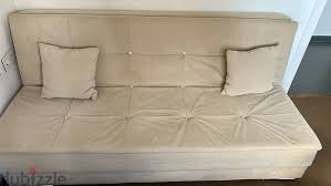 comfortable sofa bed with 2 pillows and