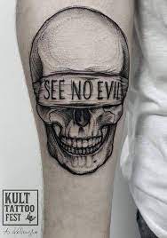 For more information and source, see on this link. Black And Gray Blindfold Skull With See No Evil Tattoo