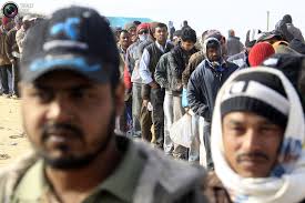 Bangladeshi migrant workers queue for food distribution at the UNHCR refugee camp near the border crossing of Ras Jdir, after fleeing the violence in Libya ... - refugees_045
