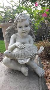 cherub and turtle garden statue